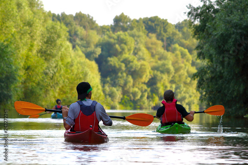 Canvas Print Group of friends (people) travel by kayaks