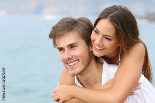 Happy couple in love with perfect smile on the beach
