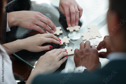 close up. business team assembling puzzle pieces.