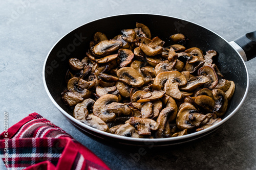 Fried and Sliced Cultivated Champignons Mushrooms in Pan.