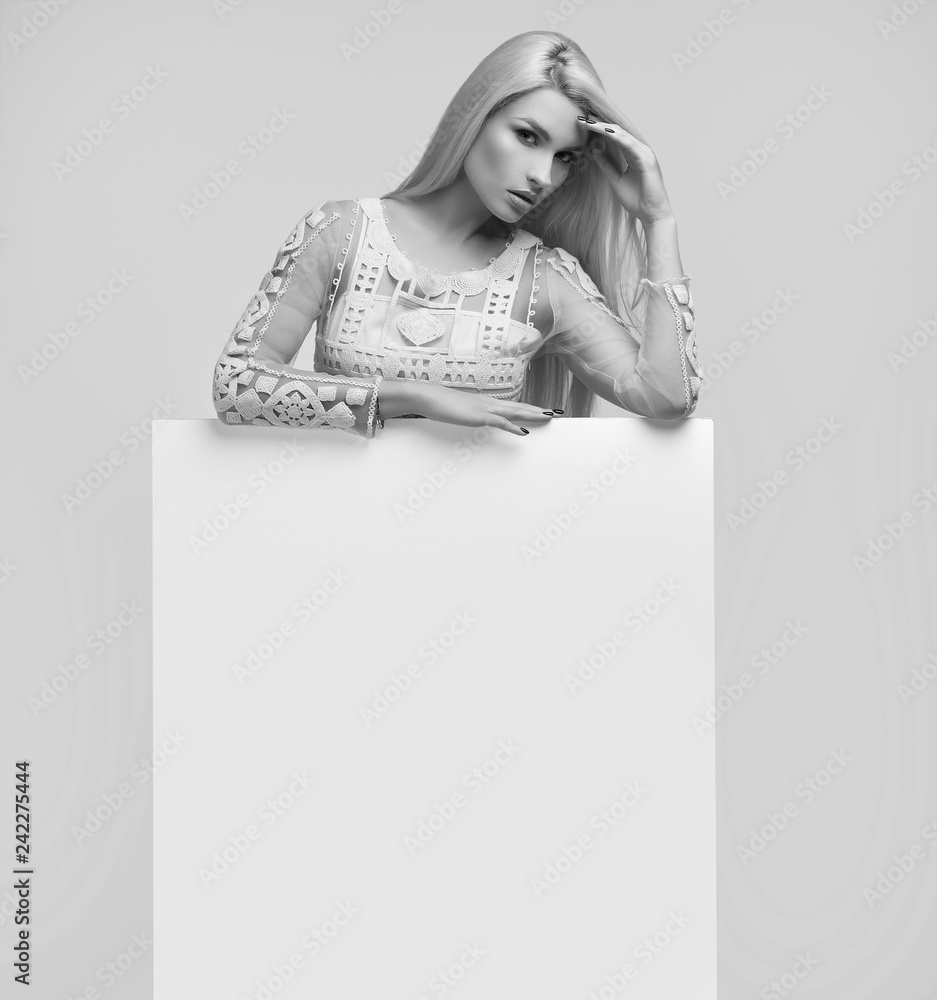 Gorgeous blonde woman holding a blank billboard