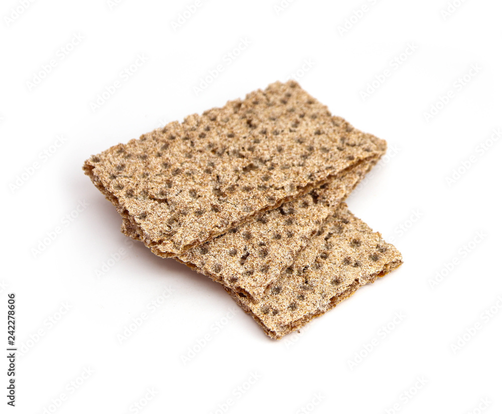 A pile of three crunchy wheat rye brown crackers, isolated on white background. Healthy food concept. A pile of three crunchy wheat rye brown crackers, isolated on white background. Healthy food concept.