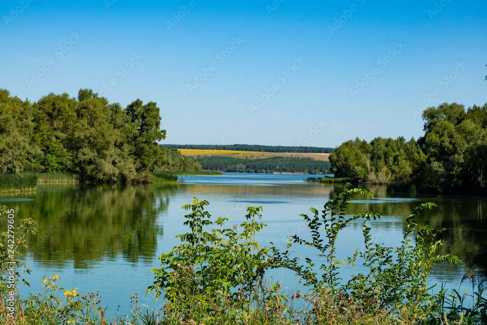 Fototapeta premium pond, river, water, reflection, forest, trees, thickets, hills, blue, sky, space, nature, landscape