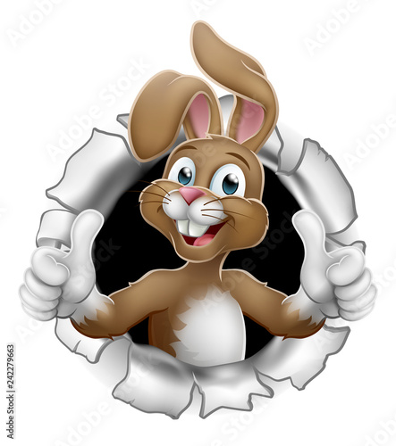 Easter bunny rabbit cartoon character breaking through the background and giving a thumbs up
