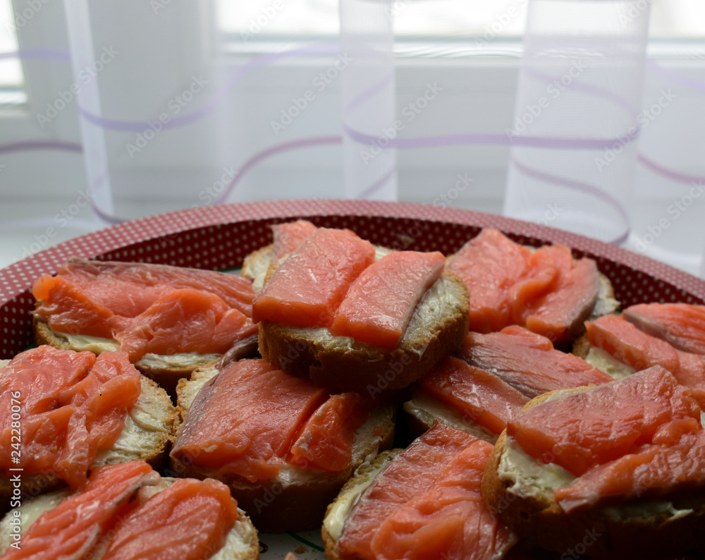 Sandwiches with butter and red fish. Salmon fillet. Festive snacks on the table. Sandwiches with butter and red fish. Salmon fillet. Festive snacks on the table.