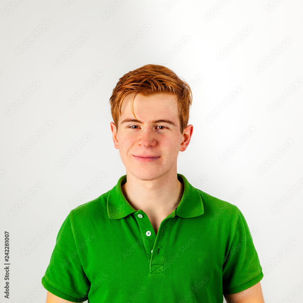 smiling boy in green shirt with red hair