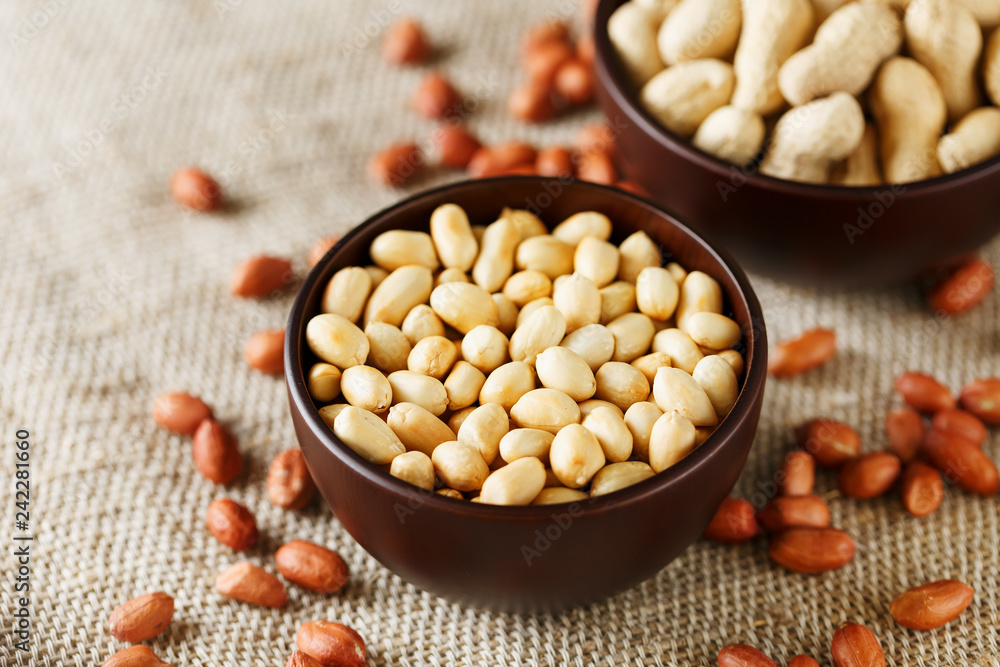 Peanuts in the shell and peeled closeup in a cup Peanuts in the shell and peeled closeup in a cup