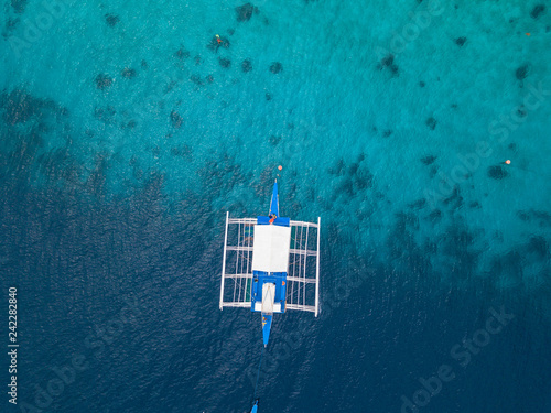 Aerial top view of traditional Philippines boat near the island Malcapuya. Turquoise water. Palawan, Philippines.