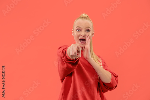 I choose you and order. Overbearing business woman point you, want you, half length closeup portrait on coral studio background. The human emotions, facial expression concept. Trendy colors