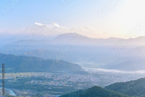 Misty Morning of the Pokhara Valley and the Himalayas Mountain Range © panithi33
