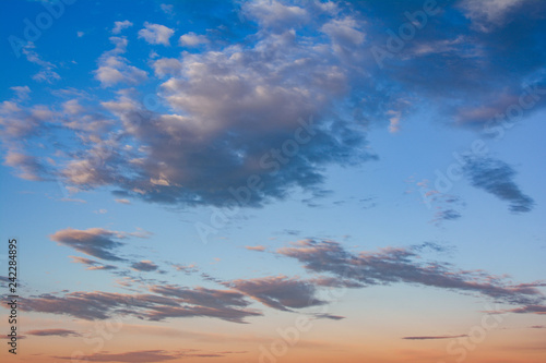 Cumulus sunset clouds with sun setting down