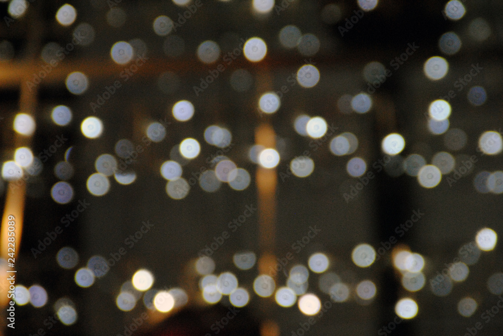Fototapeta premium Christmas background, garland lights, glass ball, toys, glare night. New Year's toys and ornaments background theme.