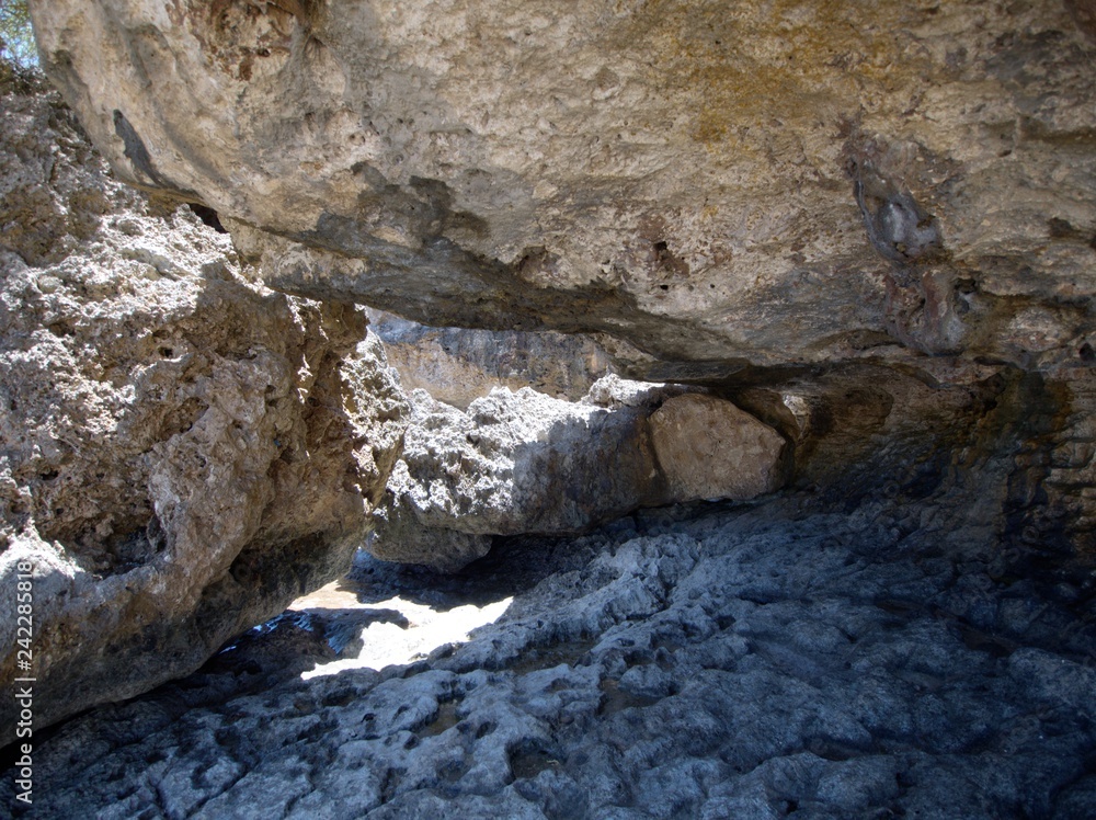 Close up of the big rocks forming a cave-like structure at a beach on Saipan