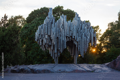 Fototapeta Naklejka Na Ścianę i Meble -  Historical monument to the composer Sibelius in the park of the city of Helsinki in Finland and the sunset through the leaves of the trees on a summer evening.