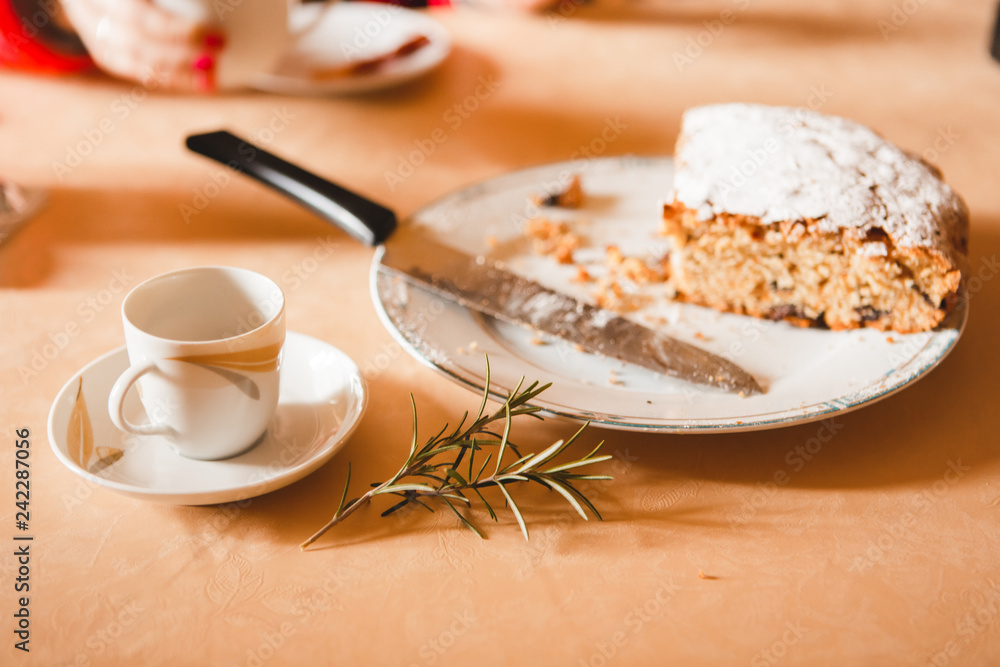 Close-up of cup of coffee and amaretto cake wit rosemary branch Close-up of cup of coffee and amaretto cake wit rosemary branch