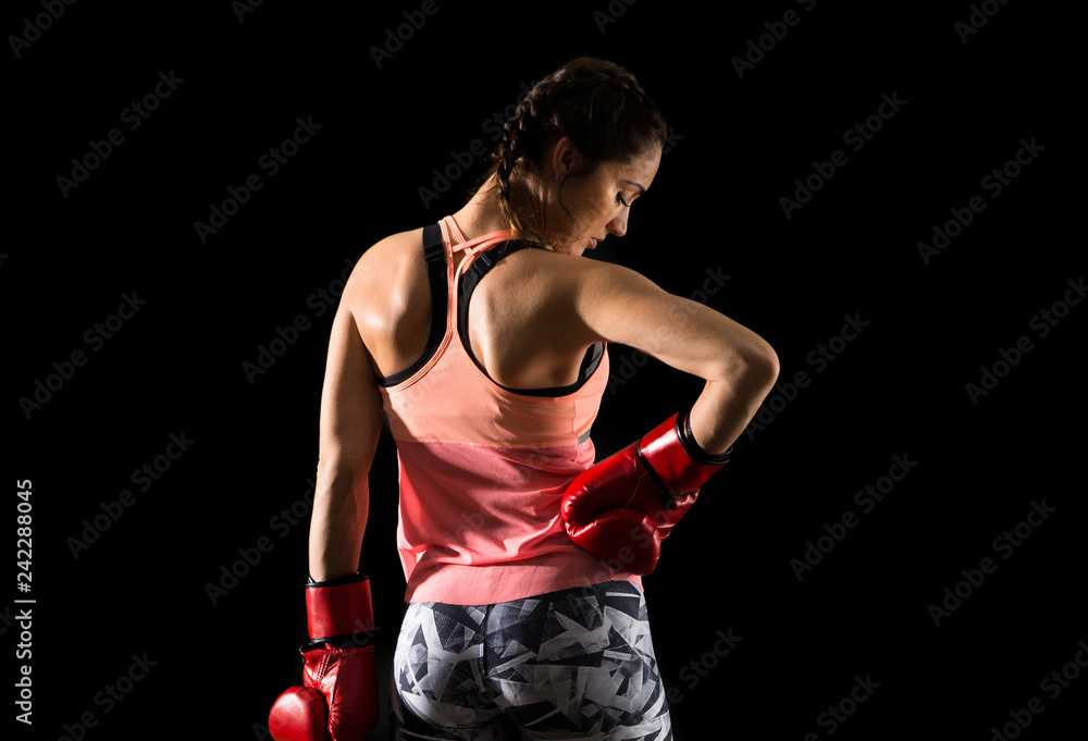 Sport woman on dark background with boxing gloves