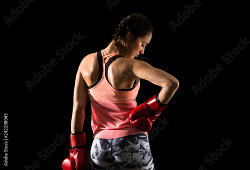 Sport woman on dark background with boxing gloves © luismolinero