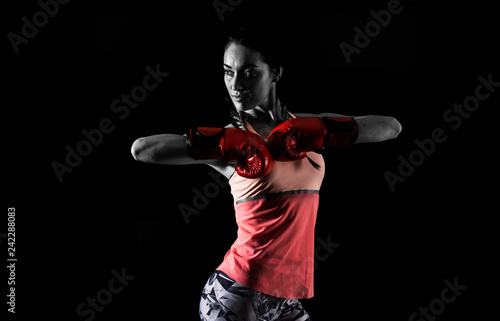 Sport woman on dark background with boxing gloves © luismolinero
