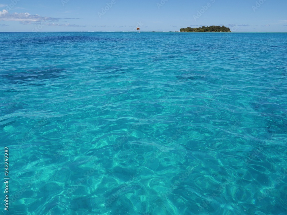 Wide shot of sparkling blue waters of Saipan lagoon, with Managaha Island in the background. Managaha is a favorite day trip destination for tourists from all parts of the world. Wide shot of sparkling blue waters of Saipan lagoon, with Managaha Island in the background. Managaha is a favorite day trip destination for tourists from all parts of the world.