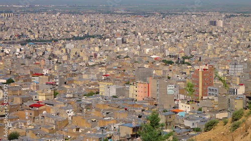 High angle view of the sprawling city of Tabriz, Iran. Large apartment blocks cover the plains at the foot of the desert.