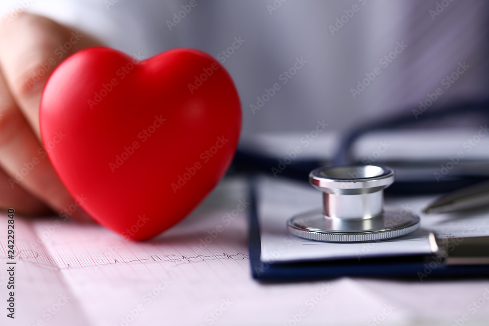Medical stethoscope head and red toy heart Medical stethoscope head and red toy heart