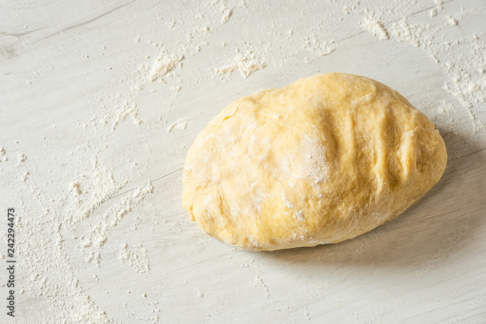 Dough for traditional bread cooking on light wooden background, copy text. Top view, flat. Dough for traditional bread cooking on light wooden background, copy text. Top view, flat.
