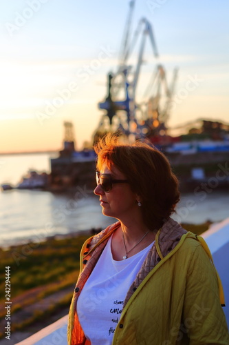 a woman in the port looks into the distance