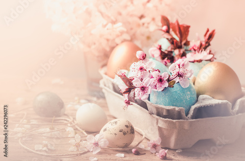 Easter eggs and spring flowers on rustic wooden background.Easter holiday card copy space.