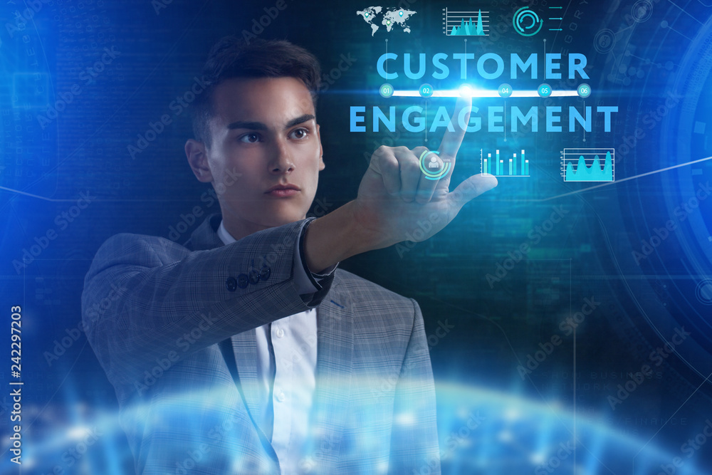 The concept of business, technology, the Internet and the network. A young entrepreneur working on a virtual screen of the future and sees the inscription: Customer engagement The concept of business, technology, the Internet and the network. A young entrepreneur working on a virtual screen of the future and sees the inscription: Customer engagement