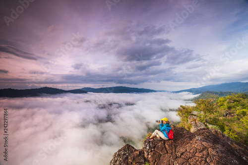 Young girl are taking photos the sea of mist on high mountain in Nakornchoom, Phitsanulok province, Thailand.