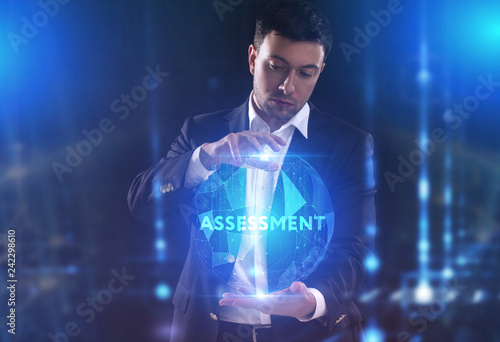 The concept of business, technology, the Internet and the network. A young entrepreneur working on a virtual screen of the future and sees the inscription: assessment