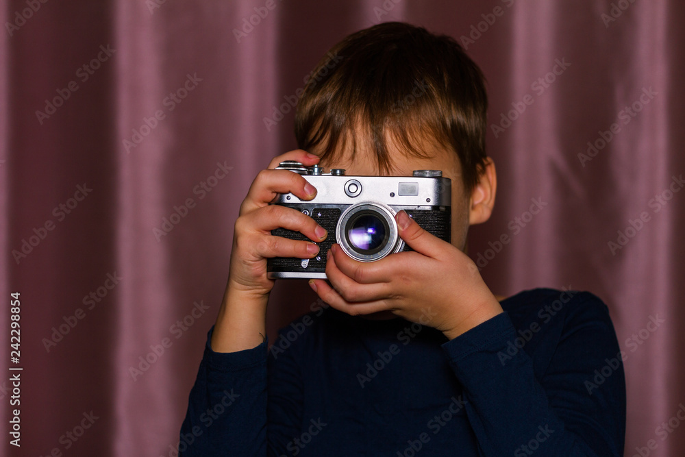Unrecognizable young boy taking a photo with a vintage film camera Unrecognizable young boy taking a photo with a vintage film camera