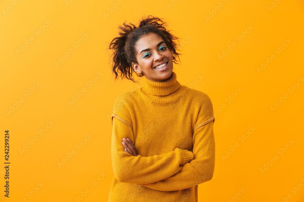 Cheerful young african woman wearing sweater Cheerful young african woman wearing sweater