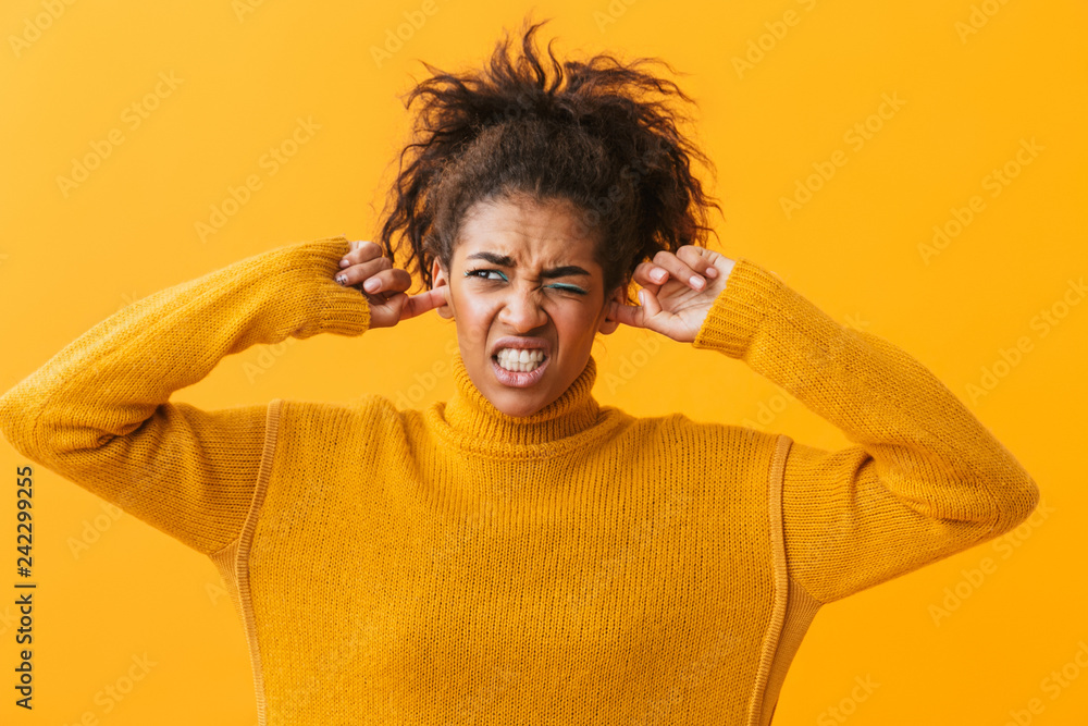 Annoyed young african woman wearing sweater Annoyed young african woman wearing sweater
