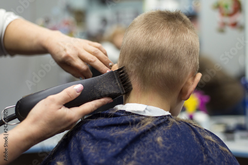 Little boy at the hairdresser. Child is scared of haircuts. © Konstiantyn Zapylaie