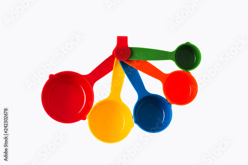 Color plastic dosing spoons isolated on a white background