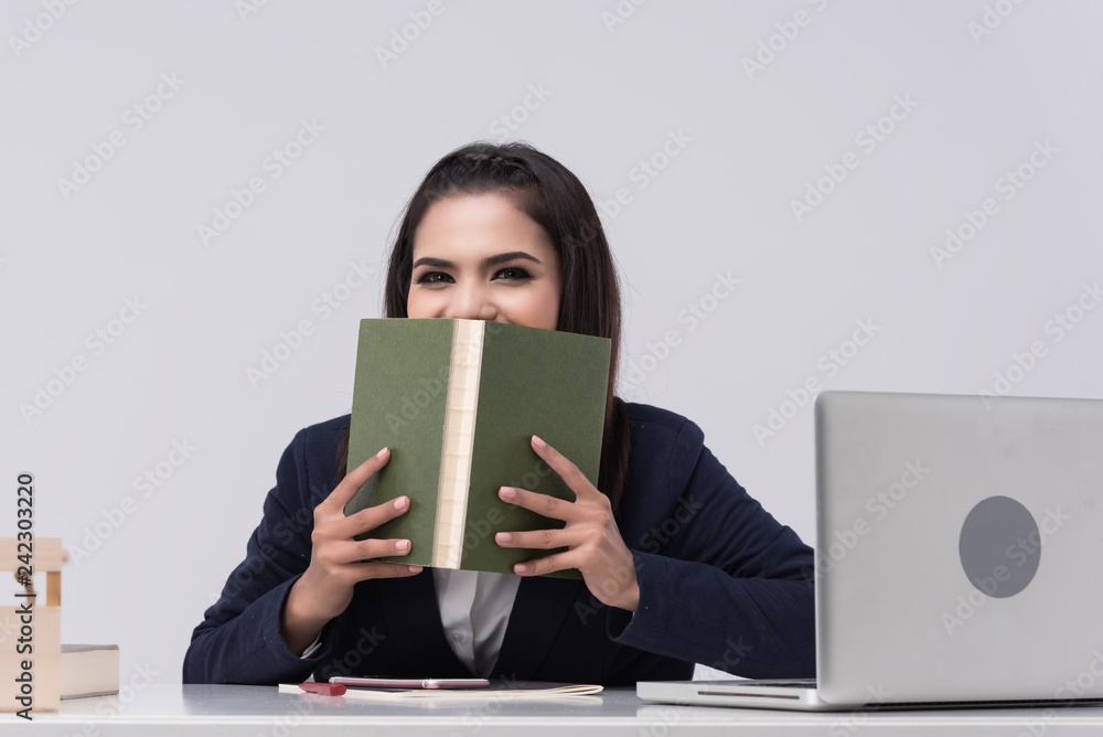 Beautiful office woman sit at table in office ,she work with laptop and use pen write report on notebook. Beautiful office woman sit at table in office ,she work with laptop and use pen write report on notebook.