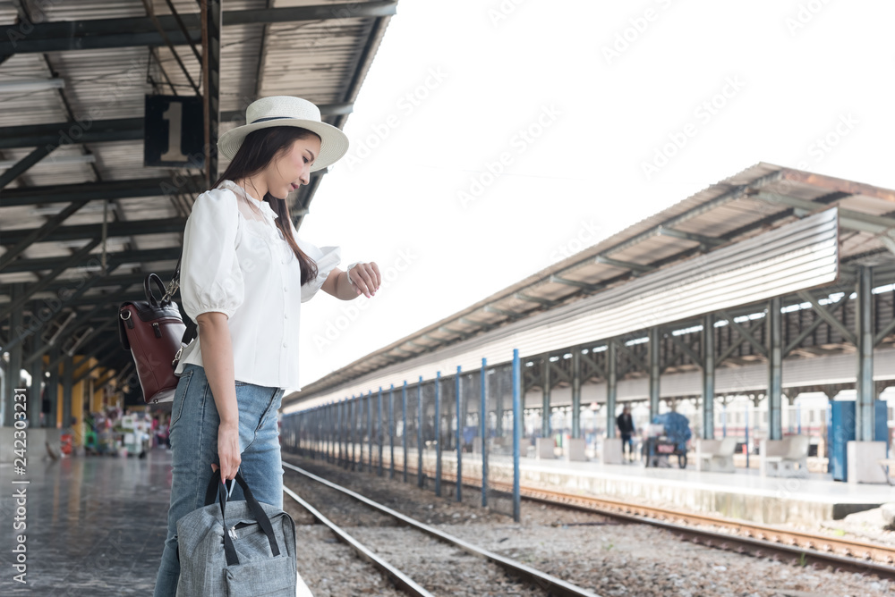 Asian traveler woman wait train at railway station.Travel holiday,relaxation concept. Asian traveler woman wait train at railway station.Travel holiday,relaxation concept.