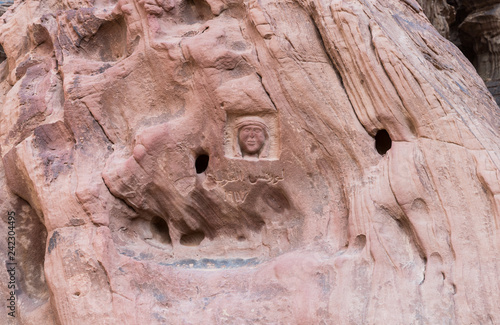 Portrait of Lawrence of Arabia and his name in Arabic carved in stone in the Wadi Rum desert near Aqaba city in Jordan photo