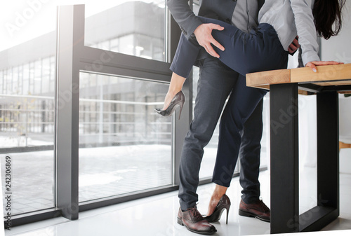 Canvas-taulu Cut view of man in suit stand and hold woman's leg in sexual pose
