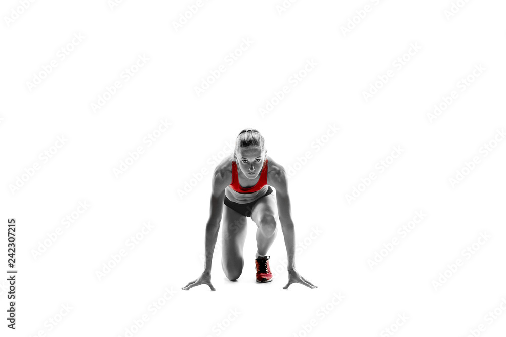 Portrait of young sporty woman at starting block of race isolated over white studio background. The sprinter, jogger, exercise, workout, fitness, training, jogging concept. Portrait of young sporty woman at starting block of race isolated over white studio background. The sprinter, jogger, exercise, workout, fitness, training, jogging concept.