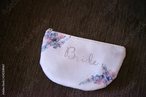 Horizontal shot of bridal accessory, a small, simple purse for the bride's essentials, ideas, concepts for bride's morning preparation. 