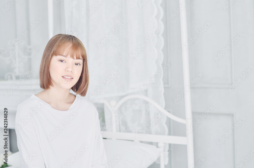 Beautiful Asian woman, white shirt, she is smiling in the morning.