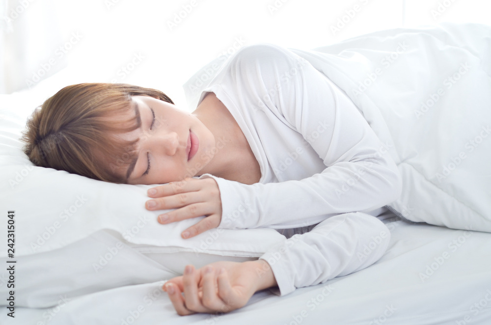 On the bed in the white room.Beautiful woman sleeping in the bedroom.Asian girl sleep well.Sleeping in a white room makes you feel comfortable.Warm tone. On the bed in the white room.Beautiful woman sleeping in the bedroom.Asian girl sleep well.Sleeping in a white room makes you feel comfortable.Warm tone.
