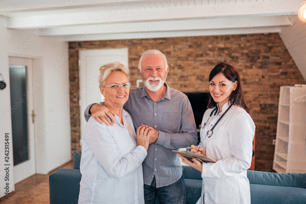 Portrait of a charming female doctor with a senior couple. Portrait of a charming female doctor with a senior couple.