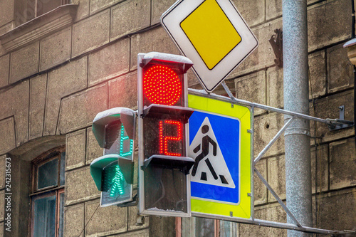 traffic lights with numbers and signs pedestrians and main road in an urban environment