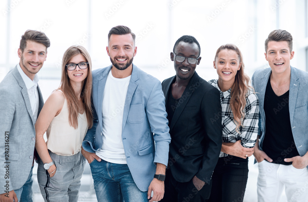 Fototapeta premium Happy group of people standing in a row over white background