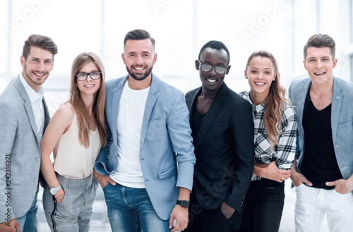 Happy group of people standing in a row over white background