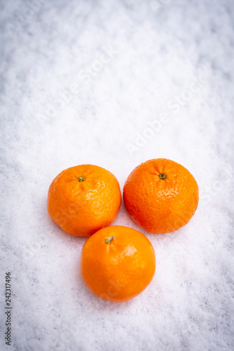 Fruits on the snow, mandarines, apples, pear © Marinka