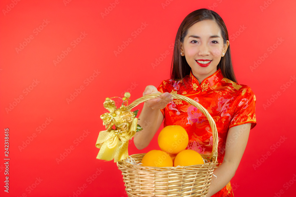 chinese new year beautiful happy smiley asia chiness girl ware Qipao Oriental Chic Cheongsam with red background copy space isolated chinese new year beautiful happy smiley asia chiness girl ware Qipao Oriental Chic Cheongsam with red background copy space isolated